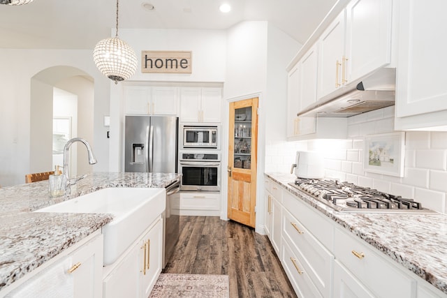 kitchen featuring dark hardwood / wood-style floors, decorative light fixtures, sink, white cabinets, and stainless steel appliances