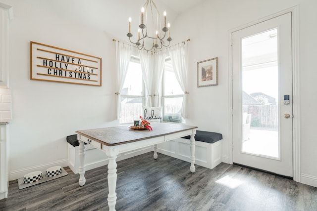 unfurnished dining area featuring dark hardwood / wood-style flooring, an inviting chandelier, and plenty of natural light