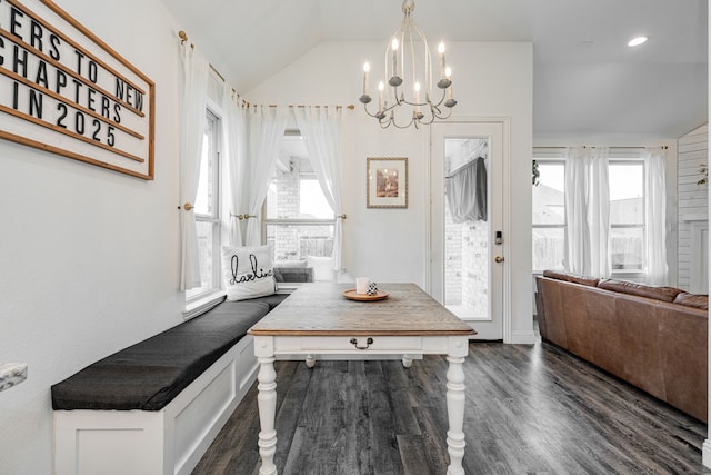 entrance foyer featuring vaulted ceiling, a chandelier, and dark hardwood / wood-style flooring