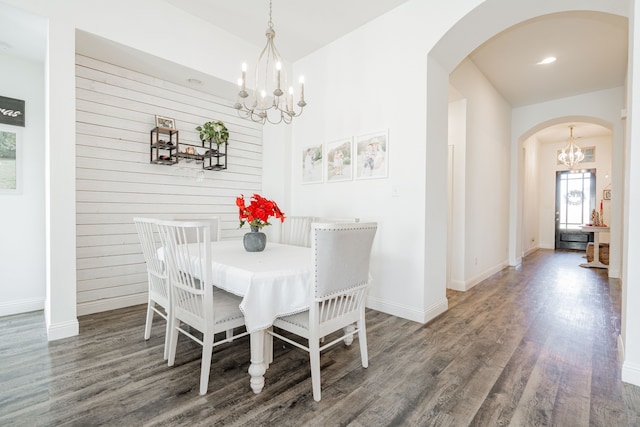 dining room featuring dark hardwood / wood-style floors and a notable chandelier