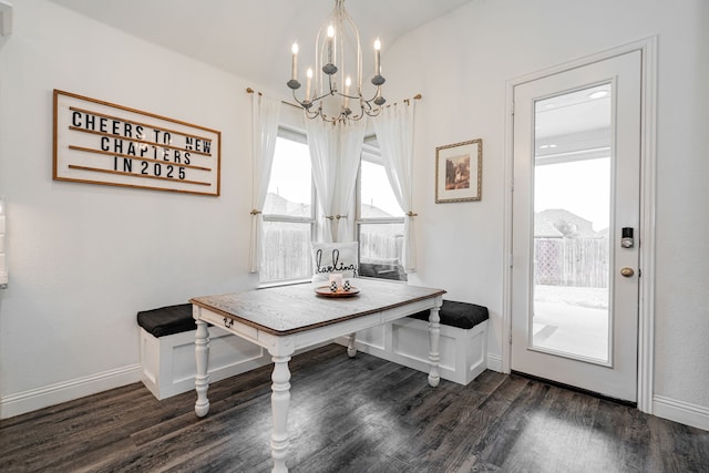 dining room featuring dark wood-type flooring and an inviting chandelier