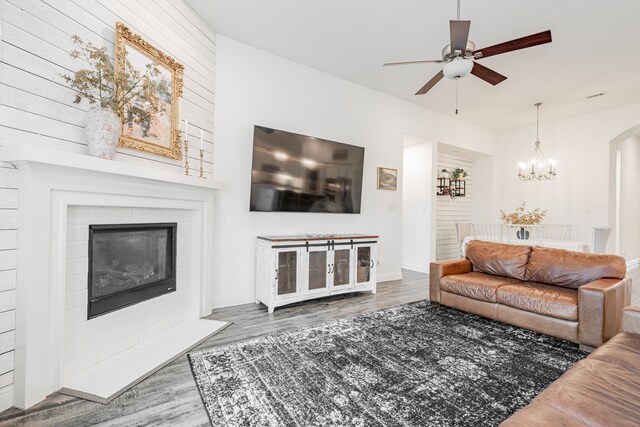 living room featuring hardwood / wood-style floors, vaulted ceiling, and ceiling fan