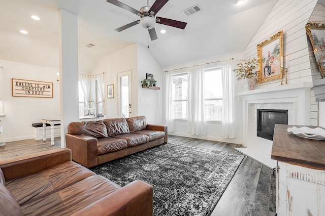 living room with dark hardwood / wood-style flooring, a fireplace, vaulted ceiling, and ceiling fan