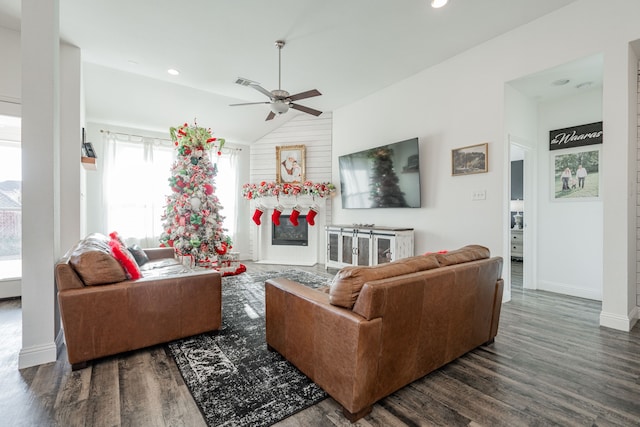 living room featuring ceiling fan, lofted ceiling, and dark wood-type flooring