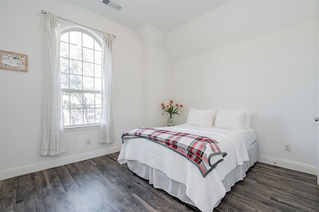 bedroom with dark hardwood / wood-style floors