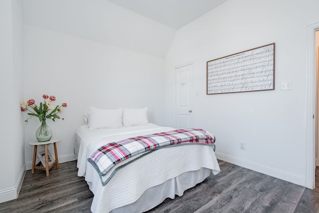 bedroom with dark hardwood / wood-style floors and lofted ceiling