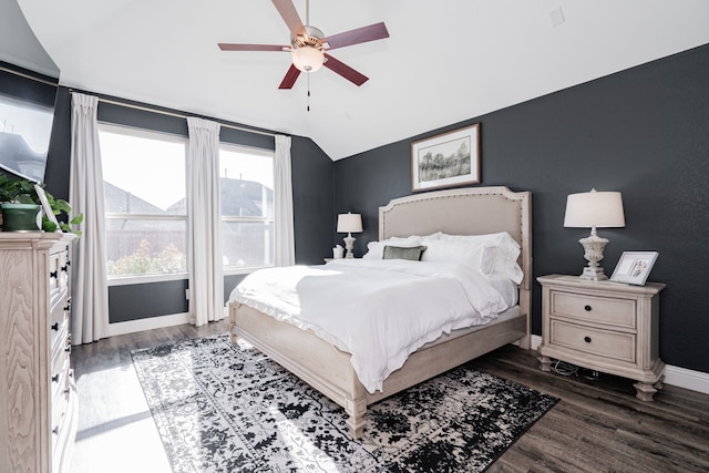 bedroom with ceiling fan, dark wood-type flooring, and lofted ceiling