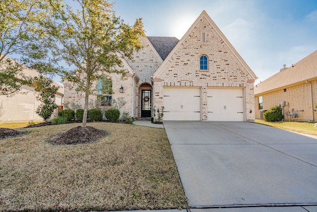 view of front facade with a garage and a front lawn