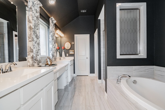 bathroom with vanity, lofted ceiling, and shower with separate bathtub