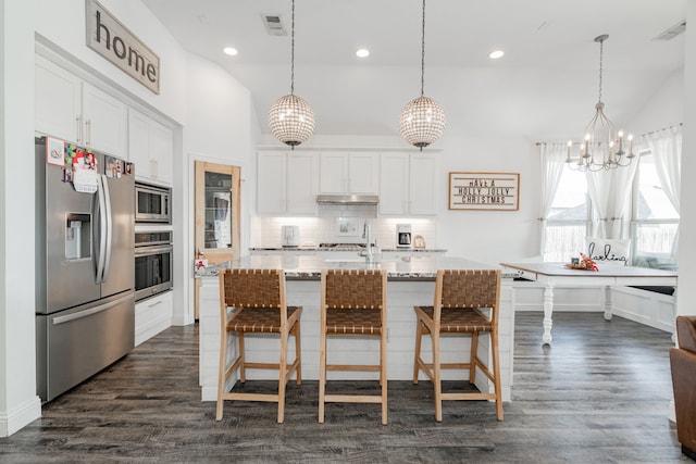 kitchen with white cabinetry, stainless steel appliances, a kitchen island with sink, and dark wood-type flooring