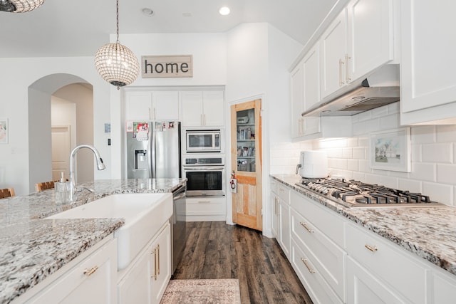 kitchen featuring sink, stainless steel appliances, dark hardwood / wood-style floors, pendant lighting, and white cabinets