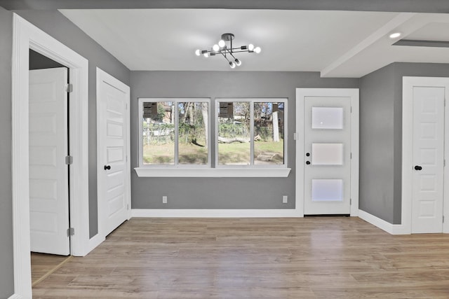 entryway featuring light hardwood / wood-style flooring and a notable chandelier