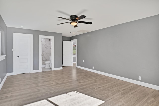 unfurnished bedroom with light hardwood / wood-style flooring, ensuite bath, and ceiling fan