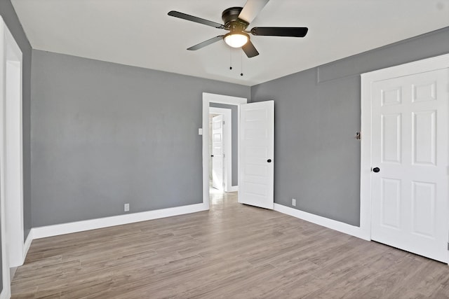 unfurnished bedroom with ceiling fan and light wood-type flooring