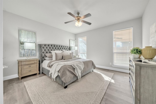 bedroom with ceiling fan and light hardwood / wood-style floors