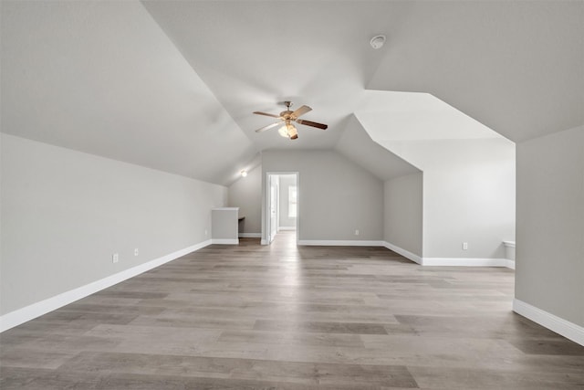 bonus room featuring light wood-type flooring, vaulted ceiling, and ceiling fan