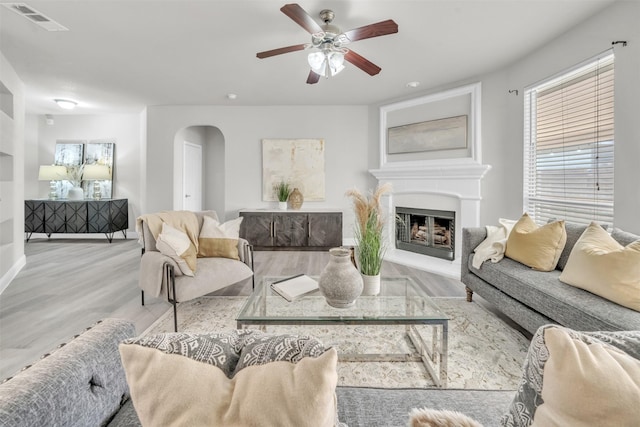 living room featuring light hardwood / wood-style floors and ceiling fan