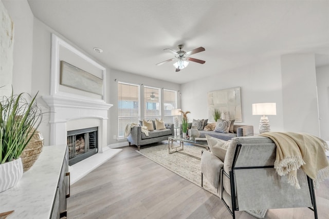 living room with ceiling fan and light hardwood / wood-style flooring