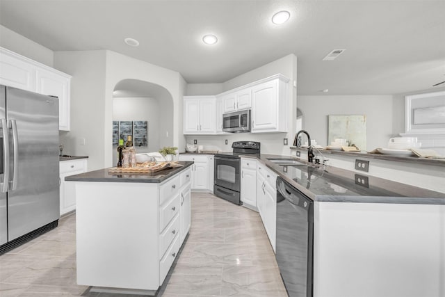 kitchen with a center island, black appliances, kitchen peninsula, sink, and white cabinetry