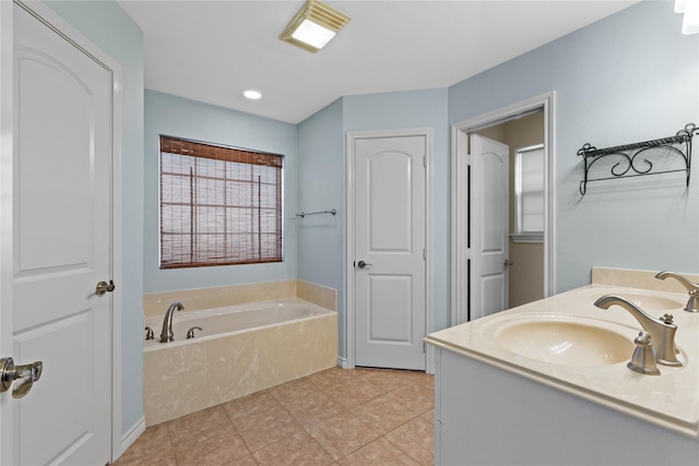 bathroom featuring tile patterned floors, vanity, and a tub to relax in