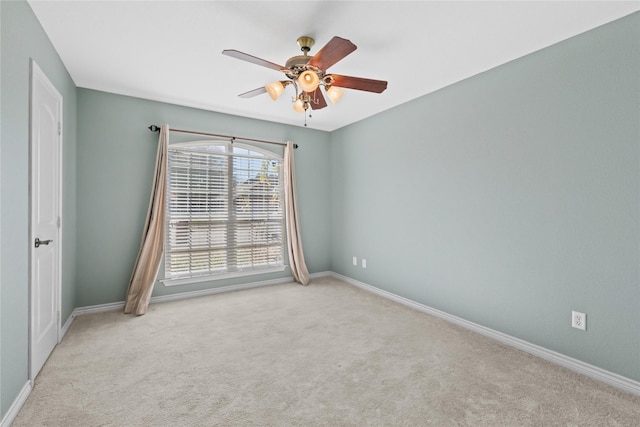 spare room with light carpet and ceiling fan