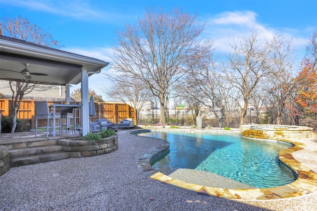 view of pool featuring a patio area, ceiling fan, and an in ground hot tub