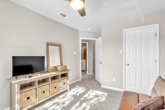 carpeted living room with ceiling fan