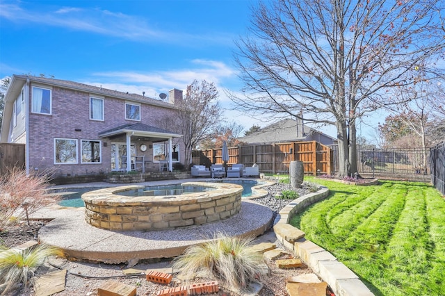 rear view of house with a fenced in pool and a yard