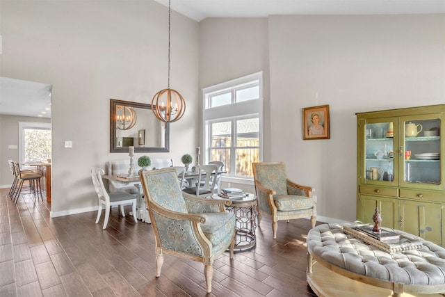 dining space featuring high vaulted ceiling, dark wood-type flooring, a wealth of natural light, and a chandelier