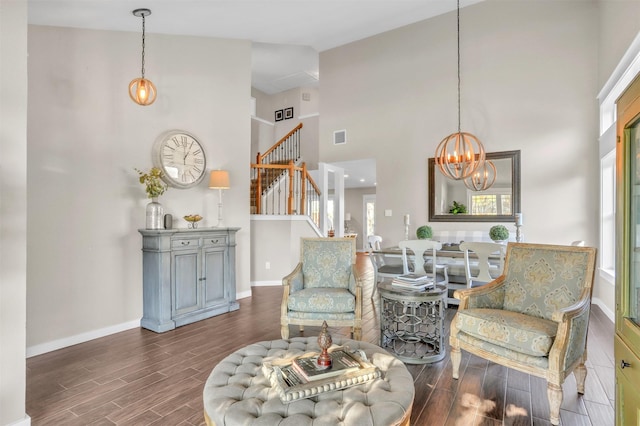 living area featuring a high ceiling and an inviting chandelier