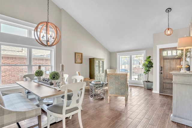 dining room featuring a notable chandelier and high vaulted ceiling