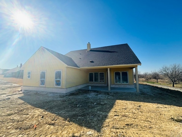 back of house with a patio