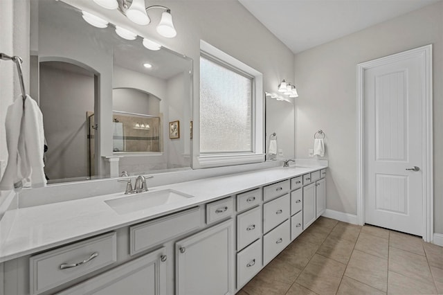 bathroom with tile patterned floors, vanity, and an enclosed shower