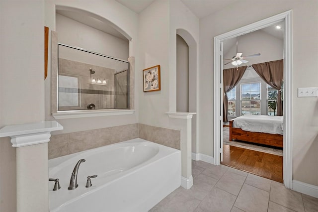 bathroom with tile patterned floors, ceiling fan, and plus walk in shower