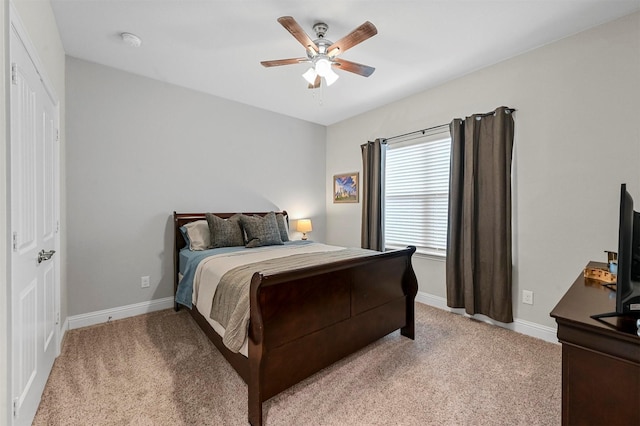 carpeted bedroom featuring ceiling fan and a closet