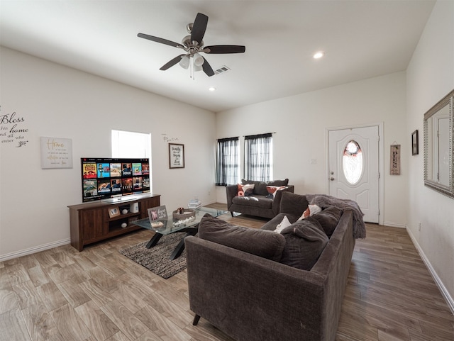 living room with ceiling fan and light wood-type flooring