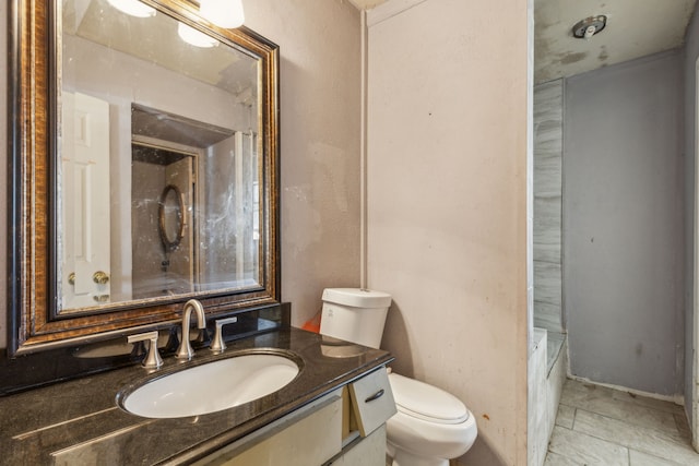 bathroom featuring vanity, toilet, and tile patterned floors