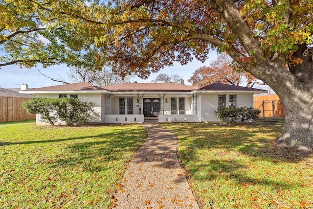 ranch-style home with a front yard and french doors