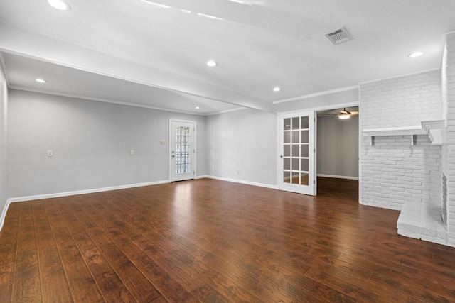 empty room featuring french doors, dark hardwood / wood-style floors, ceiling fan, and crown molding