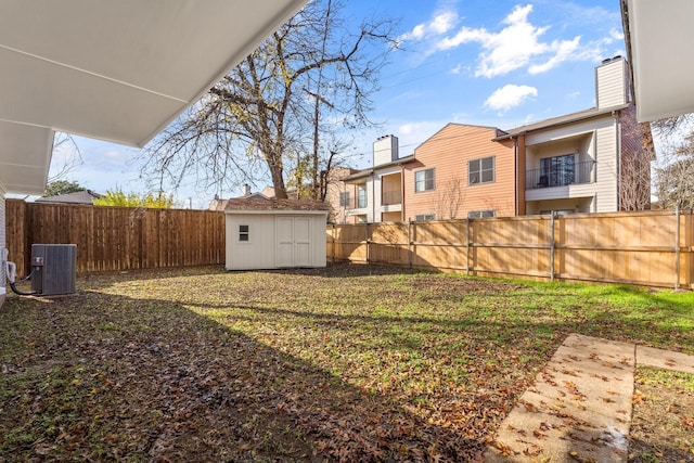 view of yard with a storage shed and central air condition unit