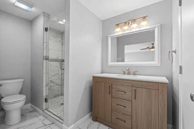 bathroom featuring vanity, toilet, and a shower with shower door