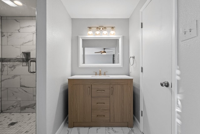 bathroom with vanity, a shower with door, and ceiling fan