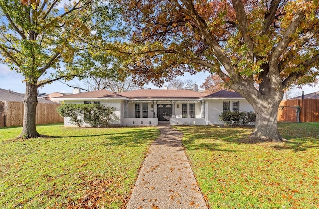 ranch-style house with french doors and a front lawn