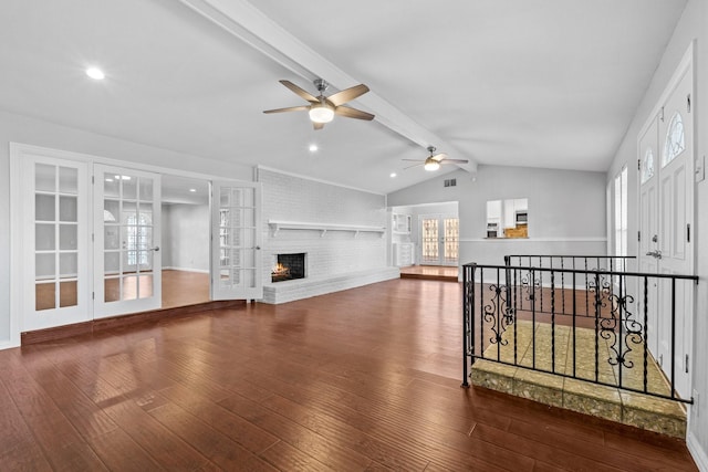 living room with a healthy amount of sunlight, dark wood-type flooring, lofted ceiling with beams, and french doors