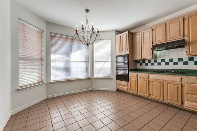 kitchen with tasteful backsplash, a wealth of natural light, black appliances, and decorative light fixtures