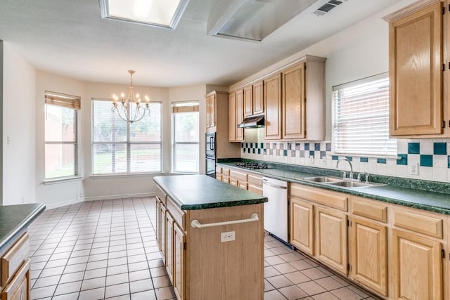 kitchen with tasteful backsplash, a healthy amount of sunlight, a kitchen island, and stainless steel appliances