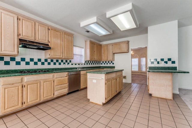 kitchen featuring a wealth of natural light, black gas stovetop, a kitchen island, and stainless steel dishwasher