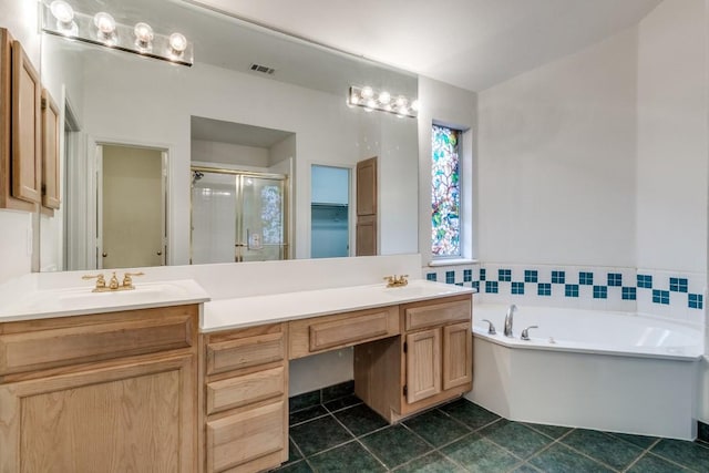 bathroom with tile patterned floors, vanity, and independent shower and bath