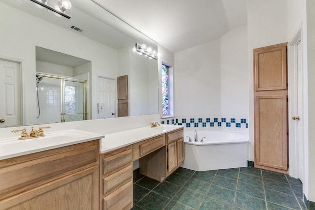 bathroom with vanity and independent shower and bath