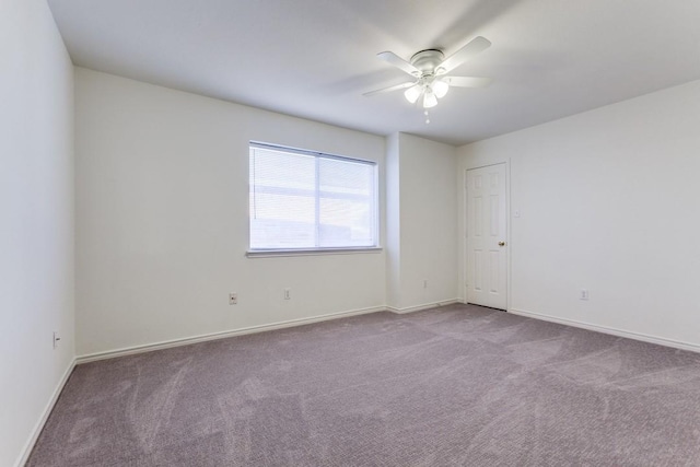 carpeted empty room featuring ceiling fan